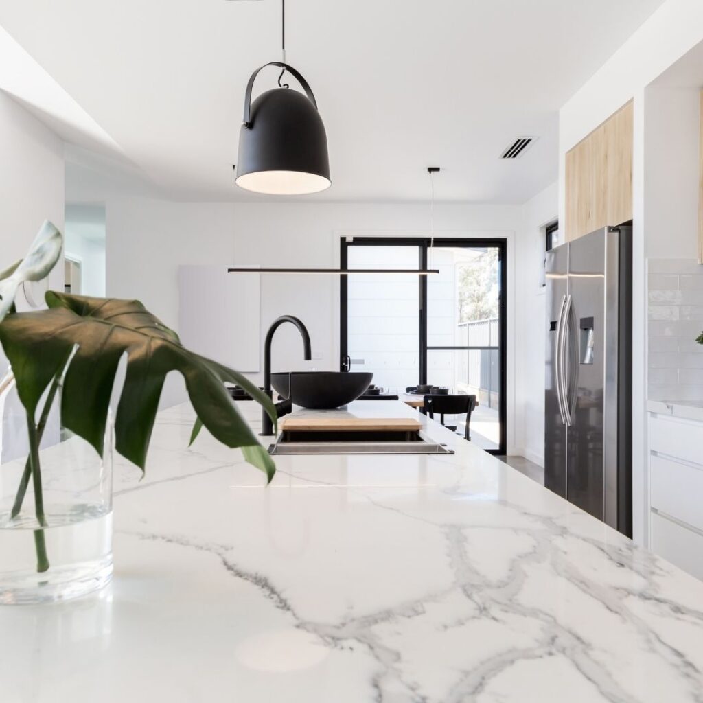kitchen with pendant light over marble countertop